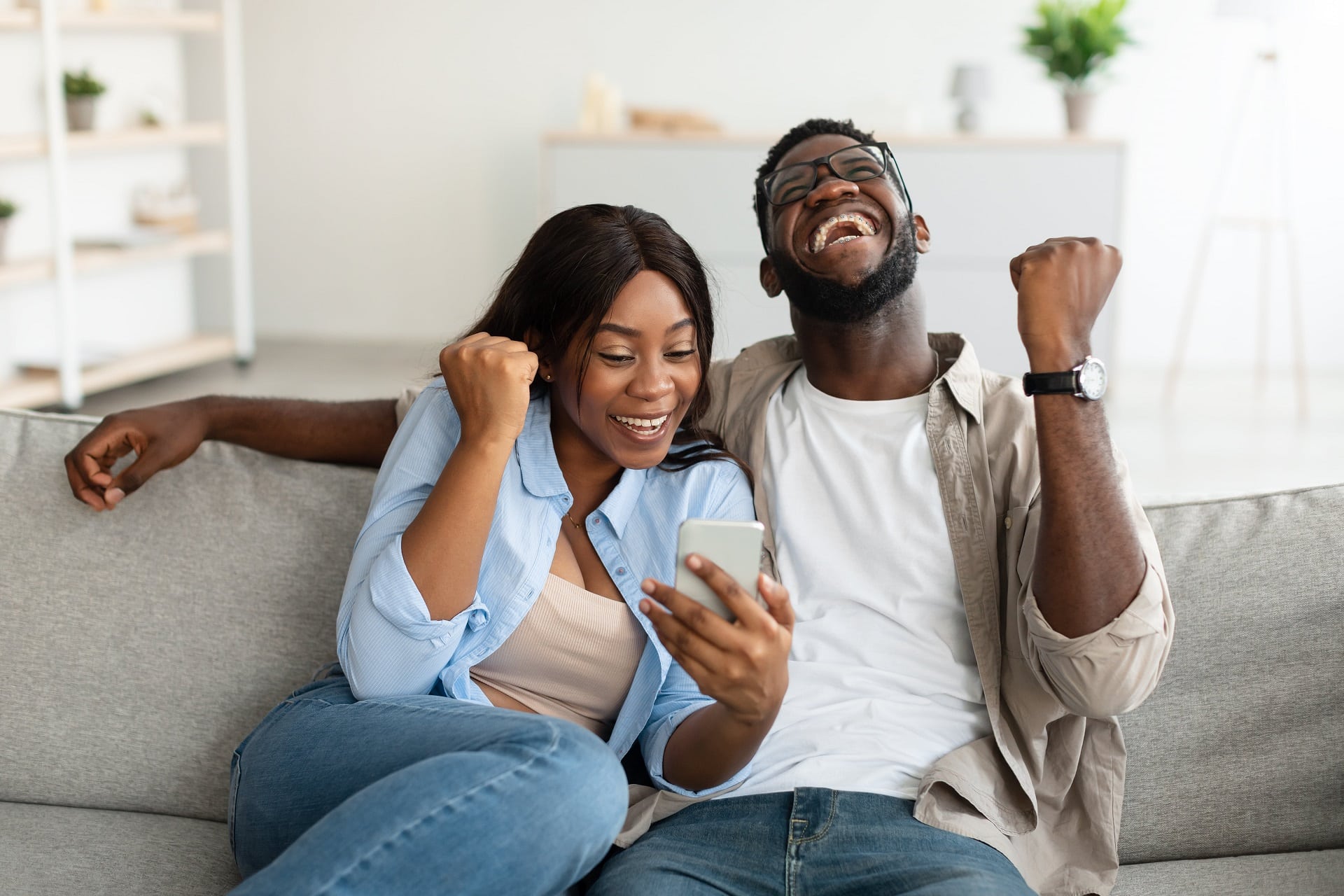 african-american-couple-using-smartphone-celebrat-2021-09-15-16-47-15-utc-min