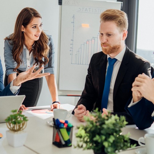 two business people at a table having a meeting about insurance